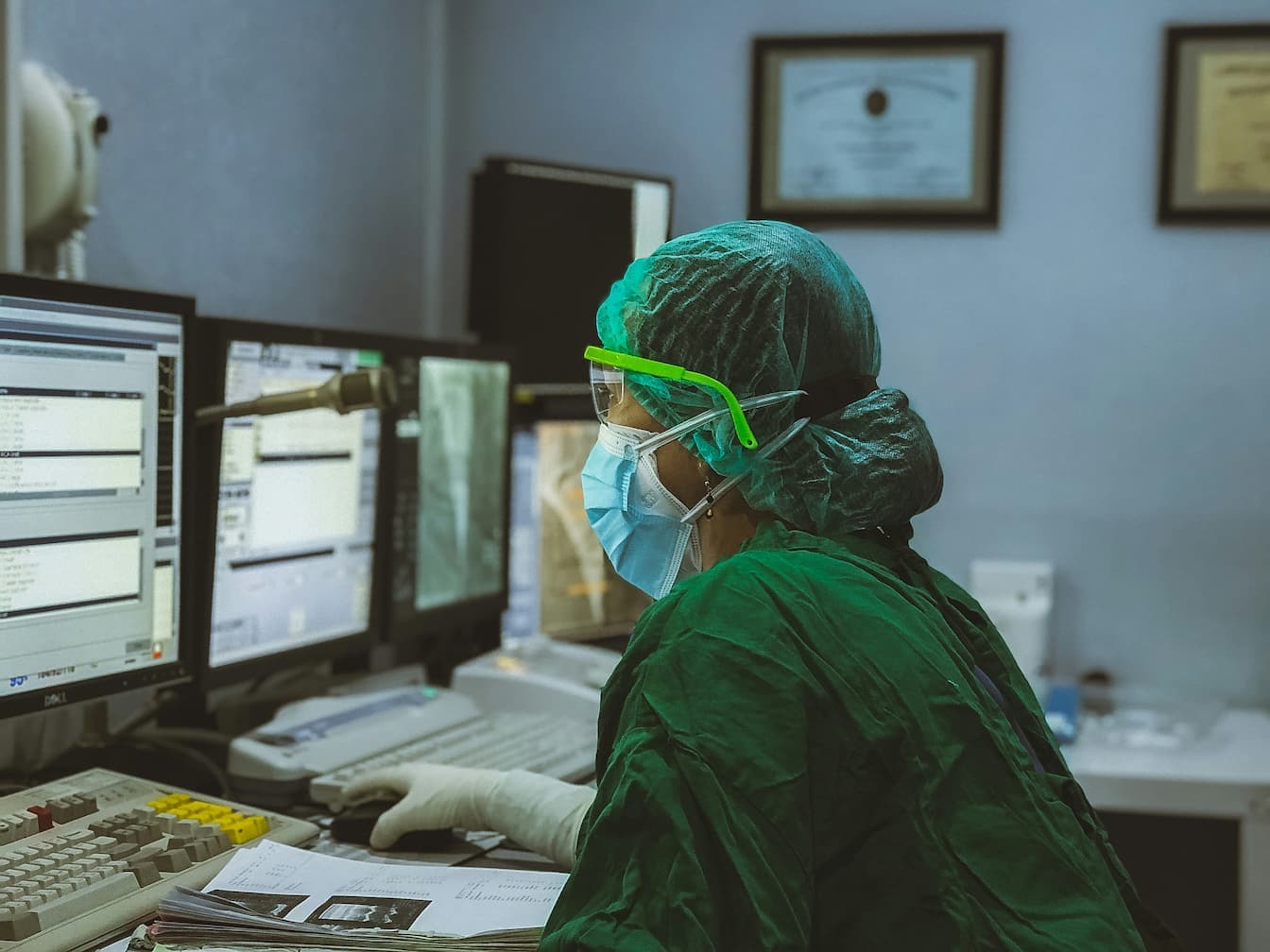 Healthcare professional working on a computer.