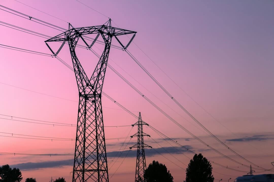 Power lines with sunset background.